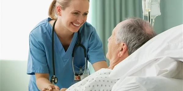 Caregiver feeding elderly patient